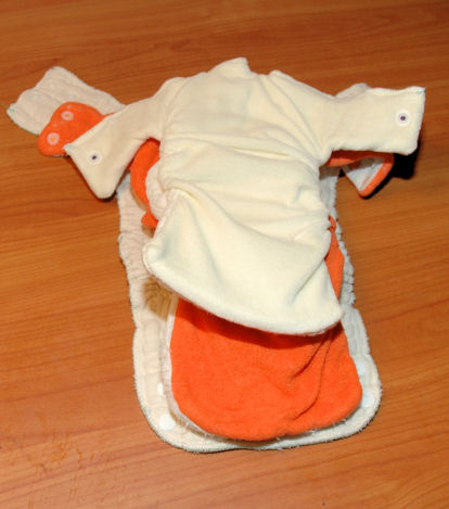 The three diapers open on top of each other to see the size difference.